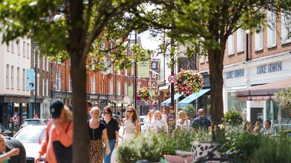 Sunlit Belgravia street with boutique shops and classic London townhouses