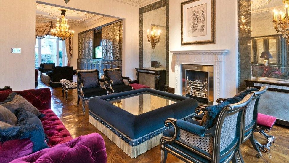 Opulent Belgravia mansion drawing room with velvet furnishings and classical fireplace